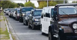  ?? RANDY HOEFT — YUMA SUN VIA AP ?? Vehicles are lined up bumper to bumper during a mass vaccinatio­n program for farmworker­s on March 15 at Joe Muñoz Park in Somerton, Arizona.