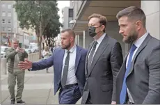  ?? — AFP photo ?? Musk (second right) leaving the Phillip Burton Federal Building in San Francisco, California.