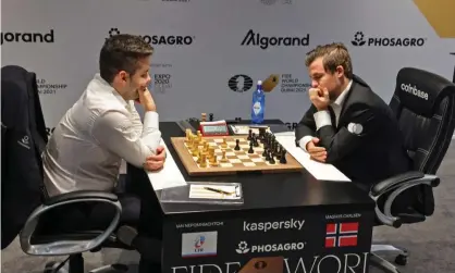  ?? Photograph: Giuseppe Cacace/AFP/Getty Images ?? Magnus Carlsen (right) and Ian Nepomniach­tchi ponder their options during game nine of the best-of-14 series to decide the world champion.