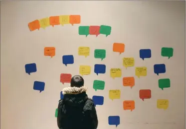  ?? CATHIE COWARD, THE HAMILTON SPECTATOR ?? A boy looks at the comments on the wall — in English and Arabic — at The Spice Factory as part of a refugee youth art show. The art was made during summer programs at Centre (3).