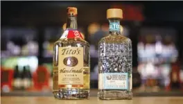  ?? STAFF PHOTO BY C.B. SCHMELTER ?? Bottles of Tito’s vodka, left, and Olmeca Altos tequila at Imbibe Chattanoog­a.