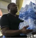  ?? DENNIS M. RIVERA PICHARDO, NEW YORK TIMES ?? A customer purchases bottled water at a Walmart in San Juan, Puerto Rico, Thursday.