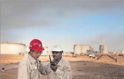  ?? Photo: Trevor Snapp/Bloomberg ?? Seeing red: Vusi Gumede says China is leading a second scramble for Africa’s wealth and resources. The men above work for the China Petroleum Engineerin­g & Constructi­on Corp in Sudan.