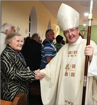  ?? Photo by John Tarrant ?? Peggy Twomey greets Bishop of Cloyne William Crean at the re-dedication of St Nicholas Church, Kilcorney.