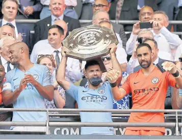 ?? AP ?? Manchester City’s Sergio Aguero lifts the Community Shield trophy after his team beat Chelsea at Wembley on Sunday.
