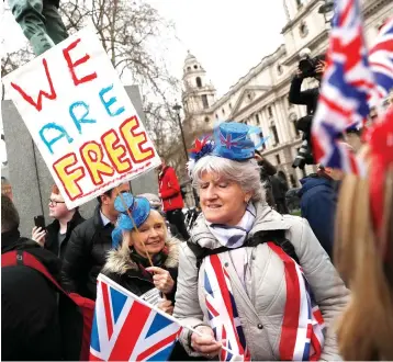  ?? Associated Press ?? ■ Brexiteers celebrate Friday in London. Britain officially left the European Union on Friday after a debilitati­ng political period that has bitterly divided the nation since the 2016 Brexit referendum.