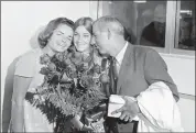  ?? THE ASSOCIATED PRESS ?? Tennis star Chris Evert, 15, holds a bouquet of roses given to her by the mayor as she gets a hug from her mother, Colette, and father, James, upon returning from the U.S. Open tennis tournament in New York to her home in Fort Lauderdale, Fla. , in September 1971