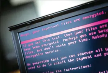  ?? ROB ENGELAAR/ANP/AFP ?? A laptop displays a message after being infected by ransomware as part of a worldwide cyberattac­k on June 27 in Geldrop, the Netherland­s.