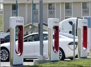  ?? ORLIN WAGNER — THE ASSOCIATED PRESS FILE ?? A Tesla charges at a station in Topeka, Kan. President Joe Biden and Democrats in Congress are looking to give U.S. automakers with union employees the inside track when it comes to winning the burgeoning electric vehicle market.