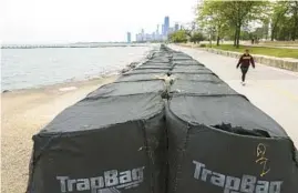  ?? JOSE M. OSORIO/CHICAGO TRIBUNE ?? Large sand bags sit along the Lakefront Trail near Fullerton Avenue in Chicago on May 24.