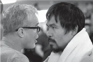  ?? ASSOCIATED PRESS ?? In this April 15, 2015 file photo, Manny Pacquiao listens to his trainer Freddie Roach during a workout in Los Angeles.