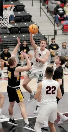  ?? Photograph by Russ Wilson ?? Senior Blackhawk Greydon Edwards, No. 21, passed the ball to a teammate during the contest against the Prairie Grove Tigers. Edwards was the high scorer with 16 points Friday, Jan. 8.