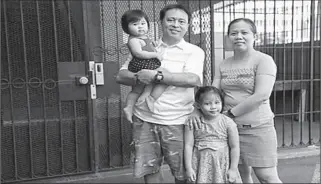  ?? HONOLULU, HAWAII, U.S
-AP ?? Judith and Jose Ramirez, a housekeepe­r and an electricia­n who were both temporaril­y laid off from their jobs at the Sheraton Waikiki Hotel due to COVID-19, pose with their daughters Mary Amber, 1, and Mary Ashley, 5, outside their home.