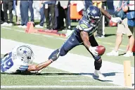  ??  ?? In this Sept 27, 2020 file photo, Seattle Seahawks running back Chris Carson (32) dives near the end zone as Dallas Cowboys cornerback Brandon Carr (39) attempts the tackle during the first half of an NFL football game in Seattle. (AP)