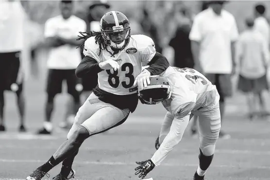  ?? Associated Press ?? n Pittsburgh Steelers wide receiver Cobi Hamilton, a former Texas High and University of Arkansas standout, tries to avoid cornerback JaCorey Shepherd on a pass route Aug. 6 during a training camp in Pittsburgh.