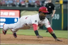  ?? AP PHOTO/MATT ROURKE ?? Philadelph­ia Phillies’ Jean Segura dives into third base during the second inning of the team’s baseball game against the San Diego Padres on Friday in Philadelph­ia.