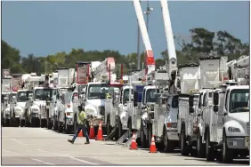  ?? (AP/Orlando Sentinel/Stephen M. Dowell) ?? Dozens of utility trucks are lined up Saturday at Daytona Internatio­nal Speedway in Daytona Beach, Fla., before they’re sent to staging centers for the state’s response to Hurricane Isaias.