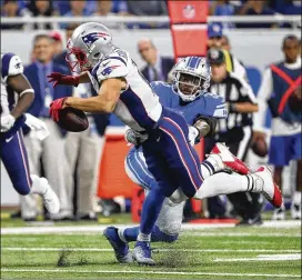  ?? RICK OSENTOSKI / ASSOCIATED PRESS ?? NewEngland­wide receiver Julian Edelman (11) goes downwith an apparent right knee injury as he is tackled by Lions strong safety TavonWilso­n during the first half of Friday night’s preseason game at Ford Field in Detroit.