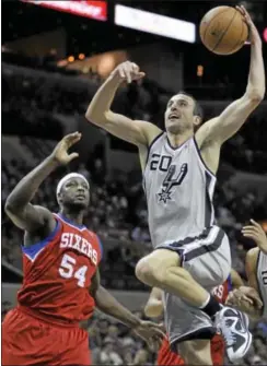  ?? AP Photo ?? The Spurs’ Manu Ginobili soars over the 76ers’ Kwame Brown during Saturday’s game in San Antonio.