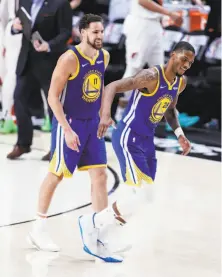  ??  ?? The Warriors’ Alfonzo McKinnie (28), with Klay Thompson, played admirably when Andre Iguodala left the game.