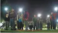  ?? PHOTOS BY PATRICK BREEN/THE REPUBLIC ?? People hold their phones with lights on to represent candles during a candleligh­t vigil for Martin Luther King Jr. in Chandler on Sunday.