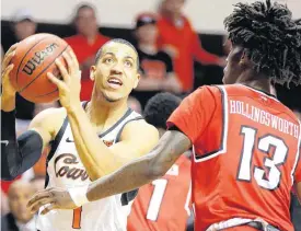  ?? [PHOTO BY BRYAN TERRY, THE OKLAHOMAN] ?? Oklahoma State’s Kendall Smith looks to shoot beside Western Kentucky’s Taveion Hollingswo­rth during Wednesday’s game.