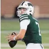  ?? EMILEE CHINN THE CANADIAN PRESS ?? Ohio Bobcats quarterbac­k Kurtis Rourke drops back to pass against the Akron Zips on Tuesday in Athens, Ohio.