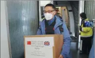  ?? XINHUA ?? A member of a Chinese medical team arrives at Heathrow Airport in London on Saturday to assist the country’s fight against COVID-19.