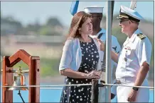  ?? TIM MARTIN/THE DAY ?? Beth Dively, left, widow of U.S. Air Force Maj. Duane Dively, is presented with a Gold Star lapel pin from Capt. Paul Whitescarv­er, right, commanding officer of Naval Submarine Base New London, on the Historic Ship Nautilus in Groton in September 2016.