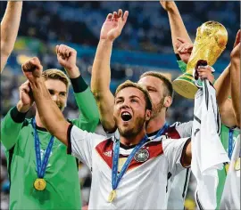  ?? MATTHIAS HANGST / GETTY IMAGES ?? Mario Goetze celebrates with the World Cup trophy after Germany defeated Argentina 1-0 in extra time during the 2014 World Cup final in Rio de Janeiro. Germany is once again a favorite in the 2018 World Cup.