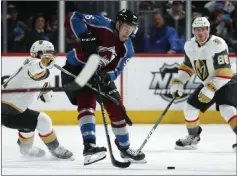  ?? David Zalubowski The Associated Press ?? Knights center Cody Eakin, left, hooks his stick around the middle of Colorado’s Mikko Rantanen in the second period of Monday’s 3-0 loss.