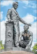  ?? J. Scott Applewhite The Associated Press ?? The Emancipati­on Memorial in Washington’s Lincoln Park, seen Thursday, depicts a freed slave kneeling at the feet of President Abraham Lincoln.