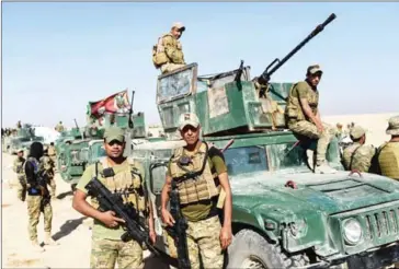  ?? BULENT KILIC/AFP ?? Forces from Iraq’s elite Rapid Response Division, which is at the forefront of the southern advance on Mosul, pose for a photo roughly 30 kilometres south of the jihadist-held city on October 21.