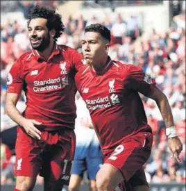  ?? AFP ?? Liverpool's Roberto Firmino (R) celebrates with Mohamed Salah after scoring their second goal against Tottenham Hotspur at Wembley on Saturday.