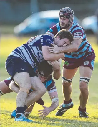  ?? HARD YARDS: Brothers’ Brendan Morgan is tackled by Teachers West’s Daniel Carman ( below) and Kit Horwood. Picture: WESLEY MONTS ??