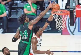  ?? AP ?? The Celtics’ Robert Williams III (44) fouls the Raptors’ OG Anunoby during the first half on Sunday.