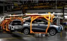  ?? CARLOS OSORIO/ASSOCIATED PRESS/FILE ?? Vehicles moved along the 2023 Chevrolet Bolt EV and EUV assembly line at the General Motors Orion Assembly in Lake Orion, Mich., in June.