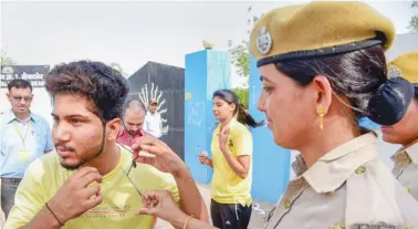  ??  ?? An applicant appearing for a Rajasthan police constable exam undergoes a check before entering an exam centre. The government had suspended Internet services across the state to prevent cheating in the exam.