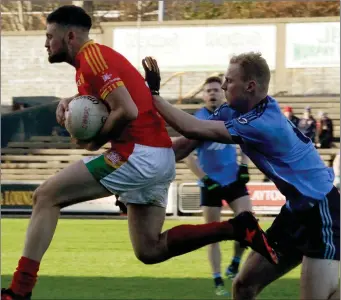  ??  ?? Richie Farrell leaps through the air after beating Simonstown’s Brian Conlon to the ball.