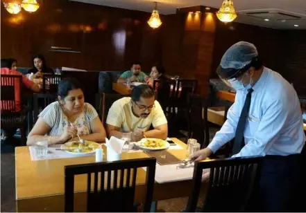  ?? XINHUA/VNA Photo ?? A restaurant in Kolkata, India. The S&P Global India Services Purchasing Managers’ Index rose to 57.9 in April.