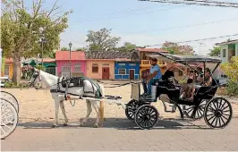  ??  ?? Touring the cobbled streets of Granada by horse-drawn carriage has become a tradition.