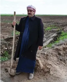  ?? ?? An Iraqi farmer stands at his agricultur­al land in the region of Hamrin, north of Tikrit, in Iraq’s province of Salaheddin.