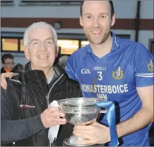  ??  ?? Naomh Mairtin captain Mick Fanning receives the O’Donnell Cup from fellow clubman and county treasurer Aidan Berrill.