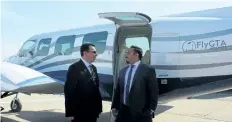  ??  ?? Jimmy Nowrouzi, FlyGTA Airline's chief financial officer, speaks to his son, company president and chief executive officer Chris Nowrouzi, standing beside one of their commuter planes, after announcing Niagara District Airport enhancemen­ts and expanded...