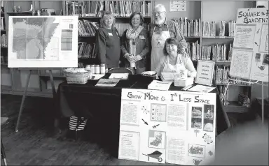  ?? Photo by Karen Benson ?? Benton County Master Gardeners Phyllis Stair, Vicki Halley, Burt Crume and Linda Crume pose at their booth at the Gravette Public Library seed swap. They displayed colorful posters with gardening informatio­n, distribute­d French marigold seeds and...