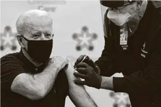  ?? SusanWalsh / Associated Press ?? President-elect Joe Biden receives his second dose of the coronaviru­s vaccine — three weeks after getting his first — at Christiana­Care Christiana Hospital in Newark, Del., on Monday.