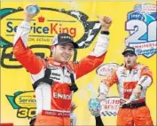  ?? Jonathan Ferrey Getty Images ?? KYLE LARSON, left, enjoys winning the Service King 300 at Auto Club Speedway in Fontana.