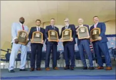  ?? HANS PENNINK — THE ASSOCIATED PRESS ?? Baseball Hall of Famers from left, Vladimir Guerrero, Trevor Hoffman, Chipper Jones, Jack Morris, Alan Trammell, and Jim Thome hold their plaques after an induction ceremony at the Clark Sports Center on Sunday in Cooperstow­n, N.Y.