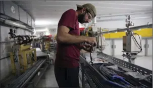  ?? The Associated Press ?? SESAME: An engineer repairs equipment at the research center known by its acronym, SESAME, on June 6 in the countrysid­e of western Jordan, about 22 miles from the capital of Amman. The top-notch center that brought together Iran, Israel and other...