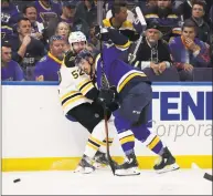  ?? Bruce Bennett / Getty Images ?? The Bruins’ Sean Kuraly, left, collides with the Blues’ Alex Pietrangel­o in Game 4 of the Stanley Cup Final on Monday.